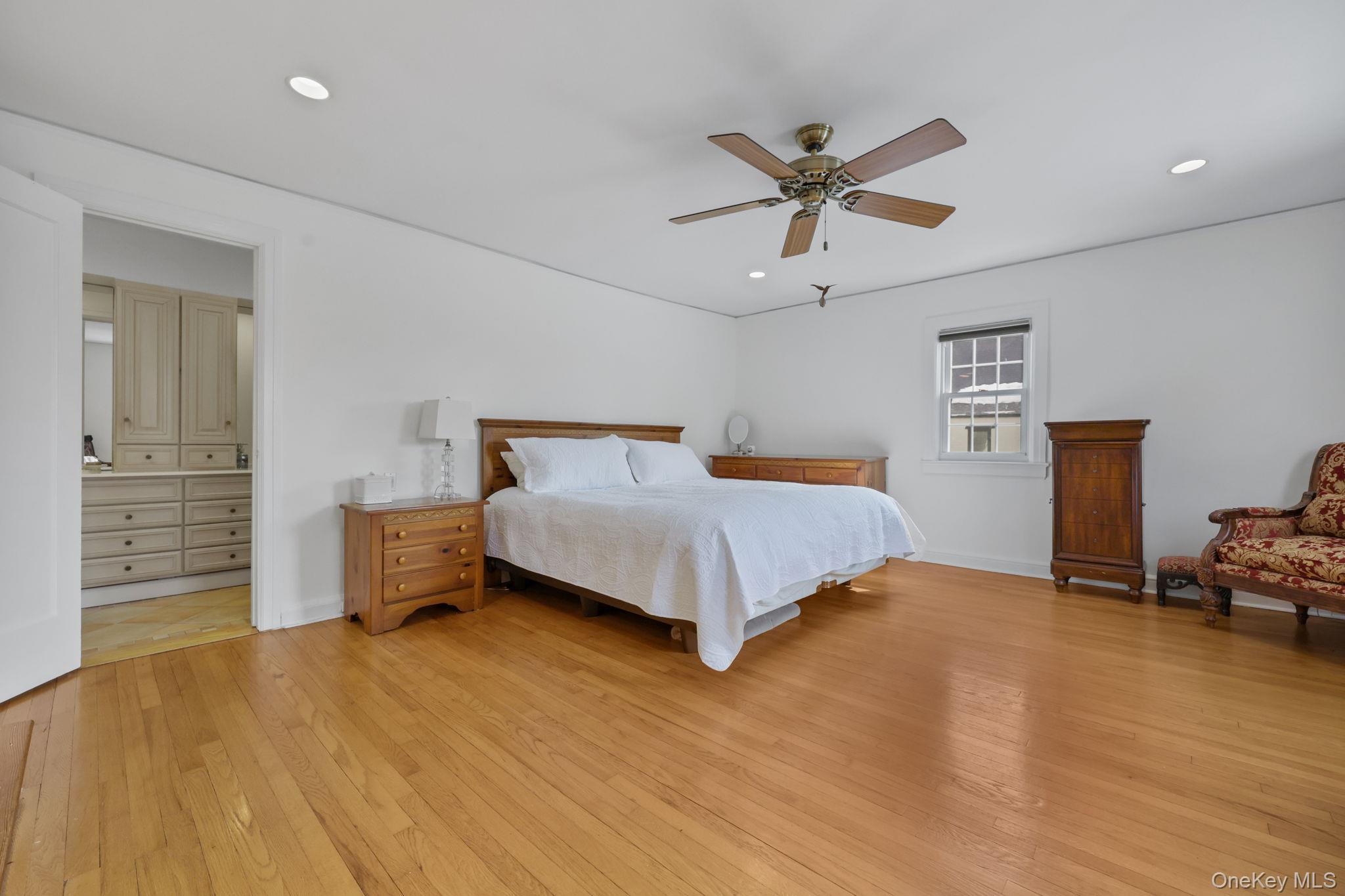 401 Heathcote Road Scarsdale, NY 10583 - Photo 17 of 41 a bedroom with a bed and a chandelier