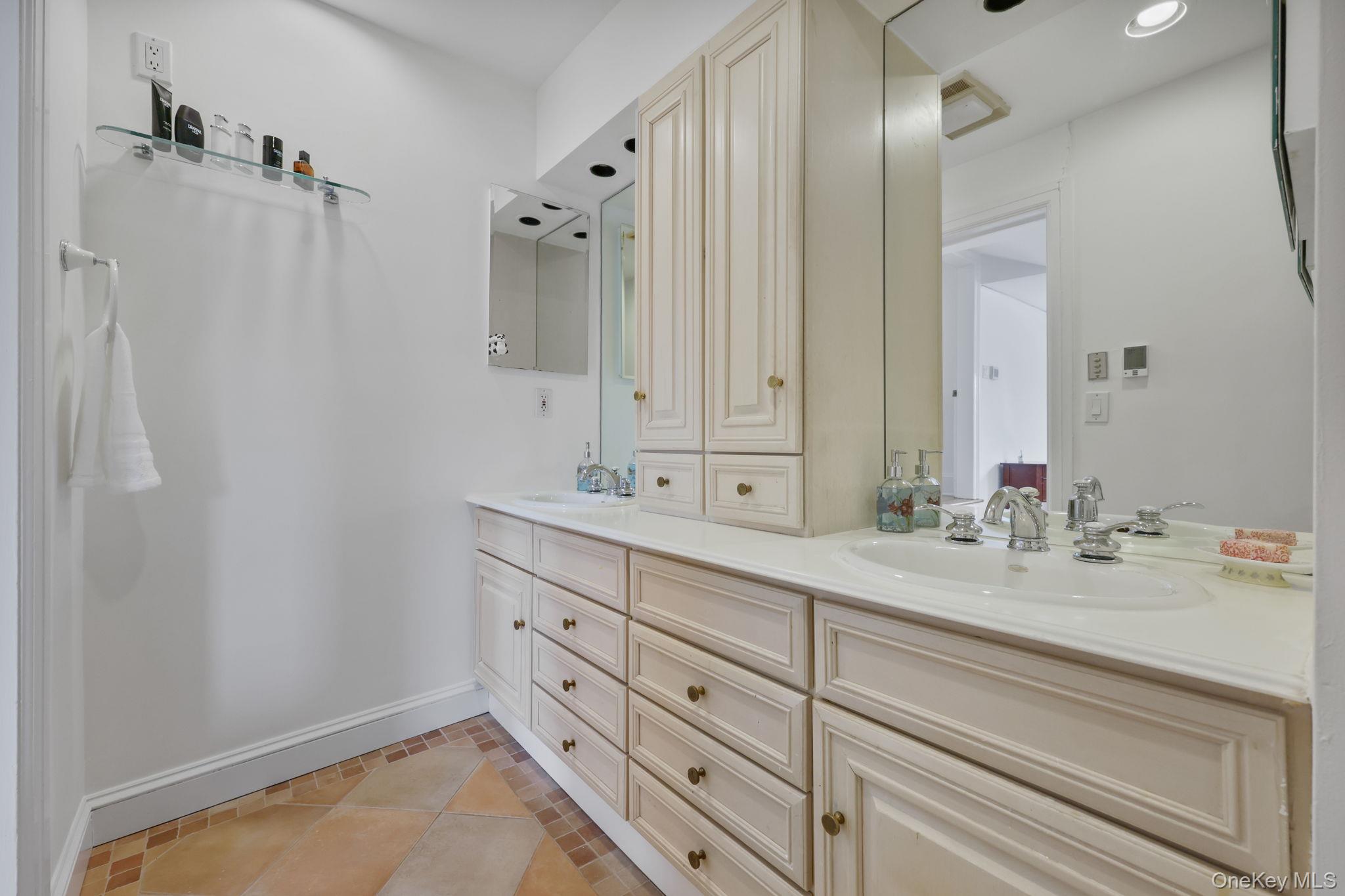 401 Heathcote Road Scarsdale, NY 10583 - Photo 18 of 41 a bathroom with a double vanity sink mirror and double