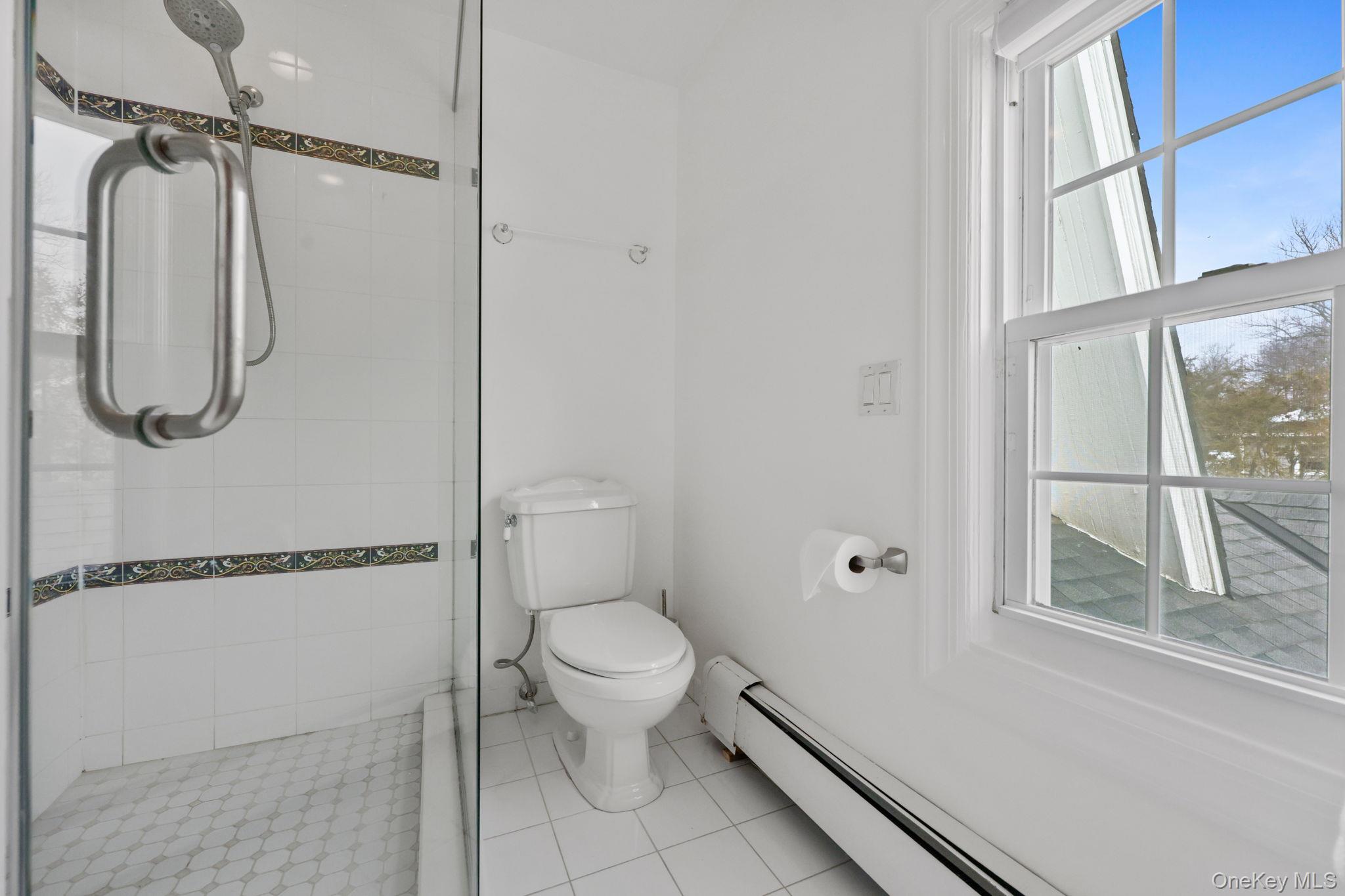 401 Heathcote Road Scarsdale, NY 10583 - Photo 19 of 41 a bathroom with a toilet and a shower