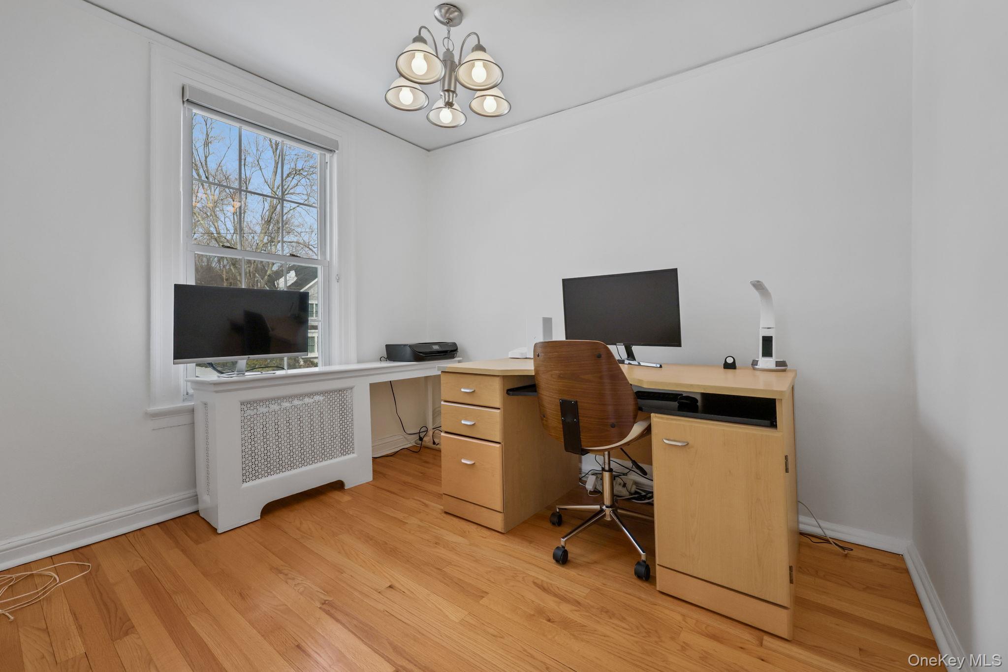 401 Heathcote Road Scarsdale, NY 10583 - Photo 21 of 41 a view of a workspace with furniture and a window