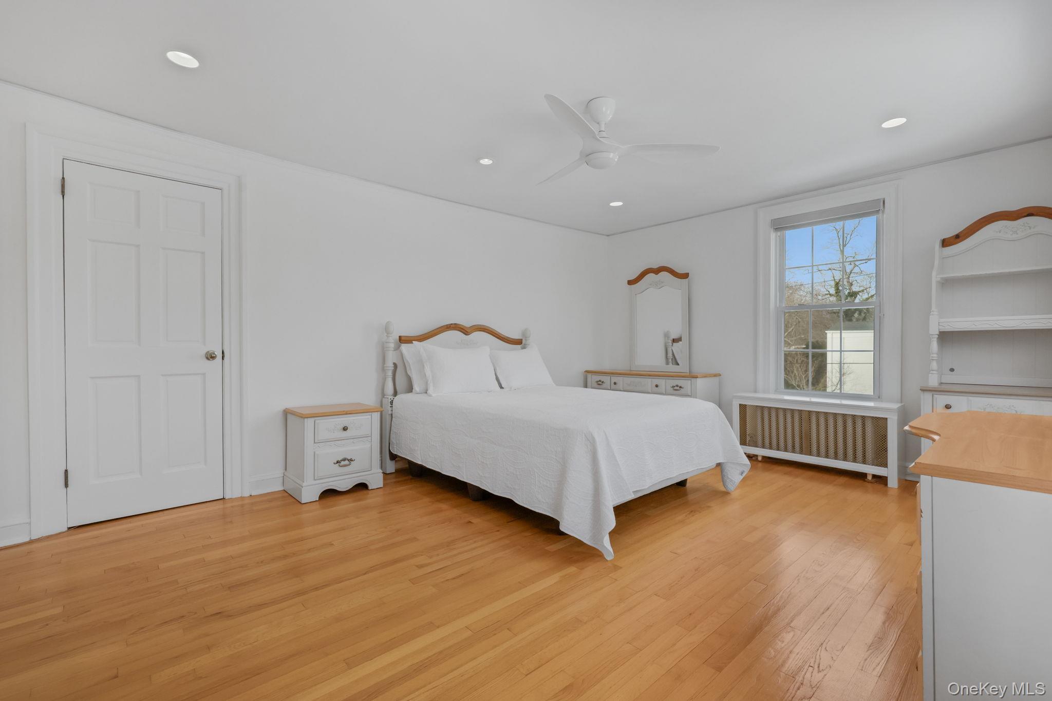 401 Heathcote Road Scarsdale, NY 10583 - Photo 22 of 41 a bedroom with a bed and a large window