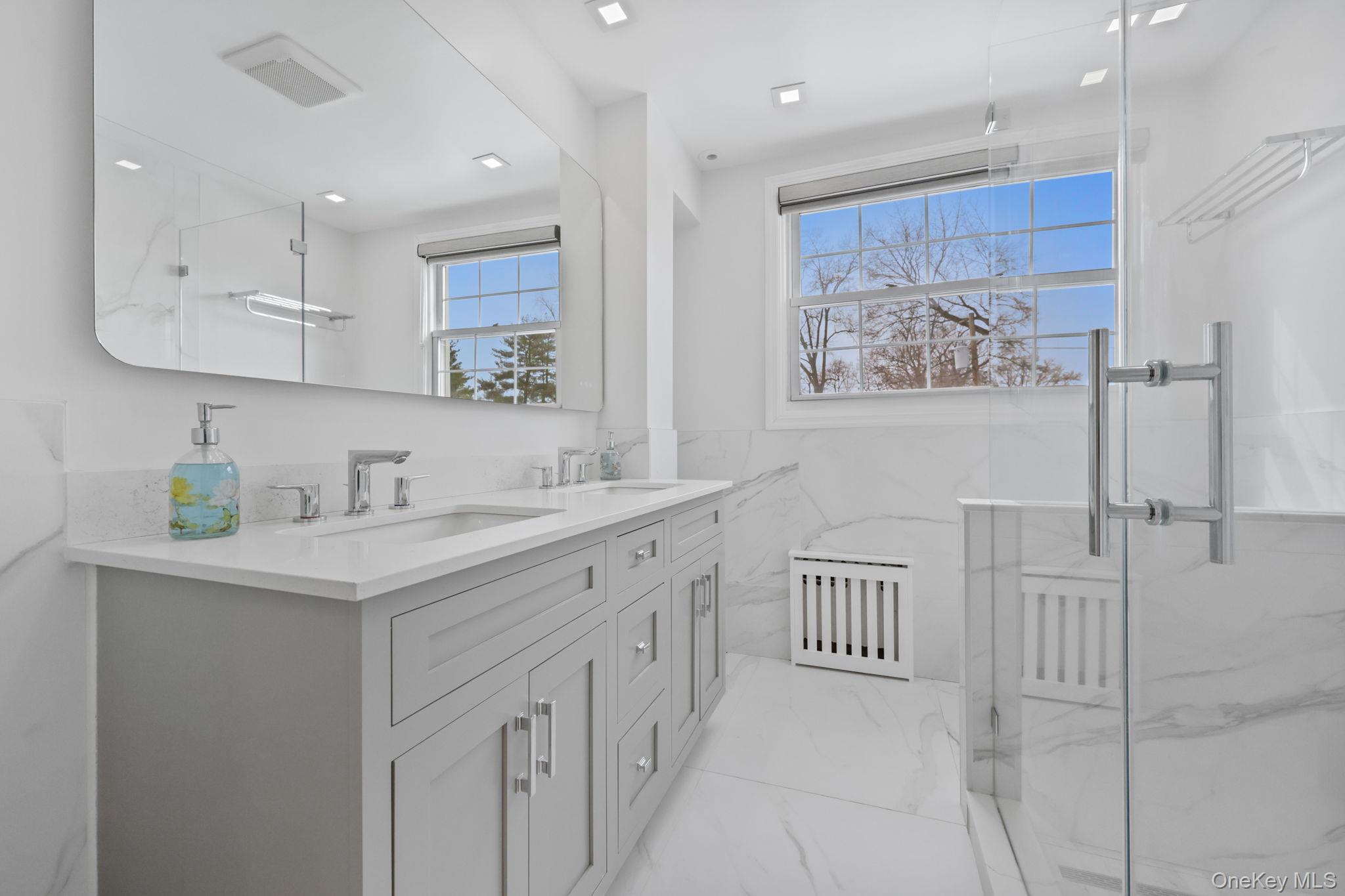 401 Heathcote Road Scarsdale, NY 10583 - Photo 23 of 41 a bathroom with a double vanity sink and a mirror