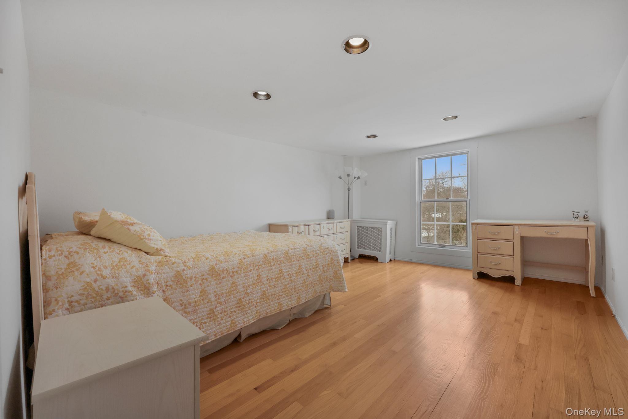 401 Heathcote Road Scarsdale, NY 10583 - Photo 26 of 41 a view of a bedroom with furniture and a window