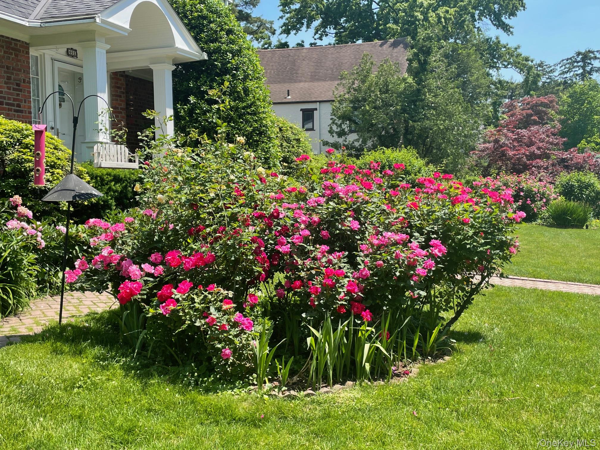 401 Heathcote Road Scarsdale, NY 10583 - Photo 31 of 41 a flower garden in front of a house