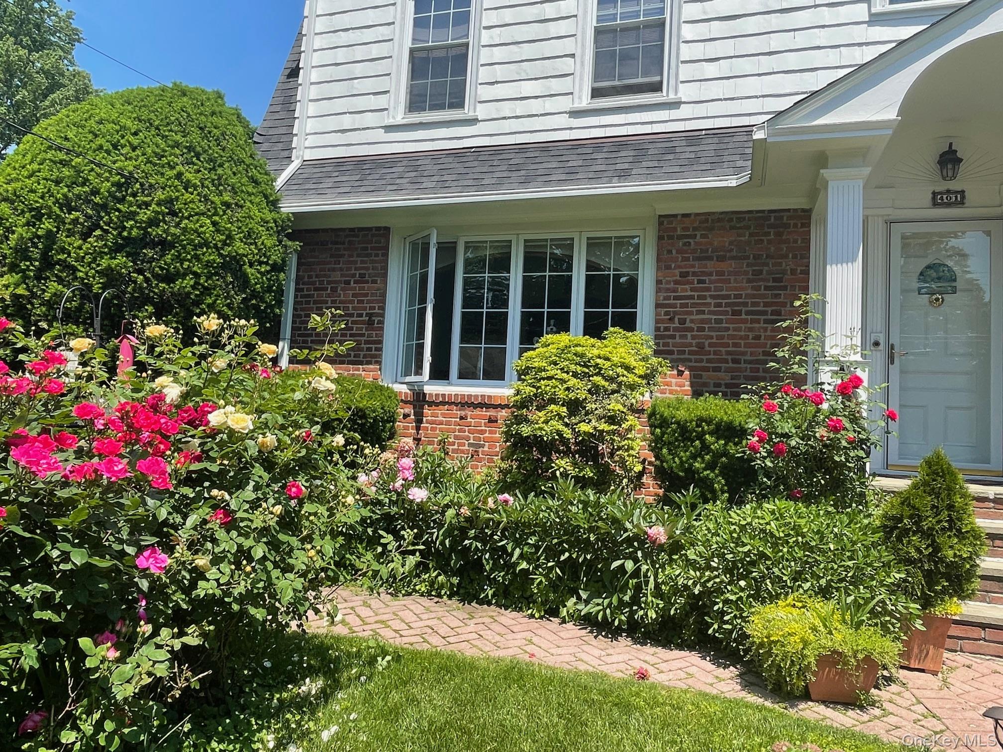 401 Heathcote Road Scarsdale, NY 10583 - Photo 34 of 41 a view of a house with potted and flower plants