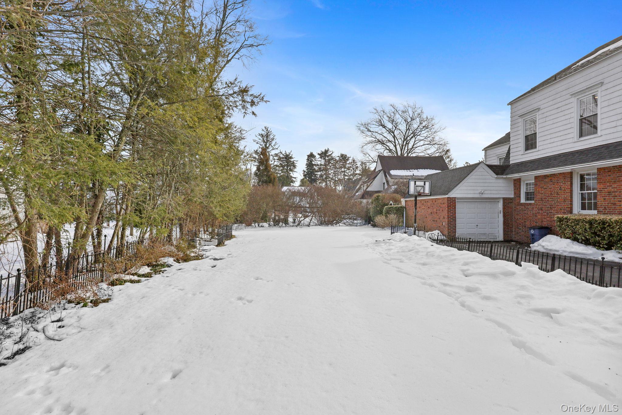 401 Heathcote Road Scarsdale, NY 10583 - Photo 36 of 41 a street view covered with snow