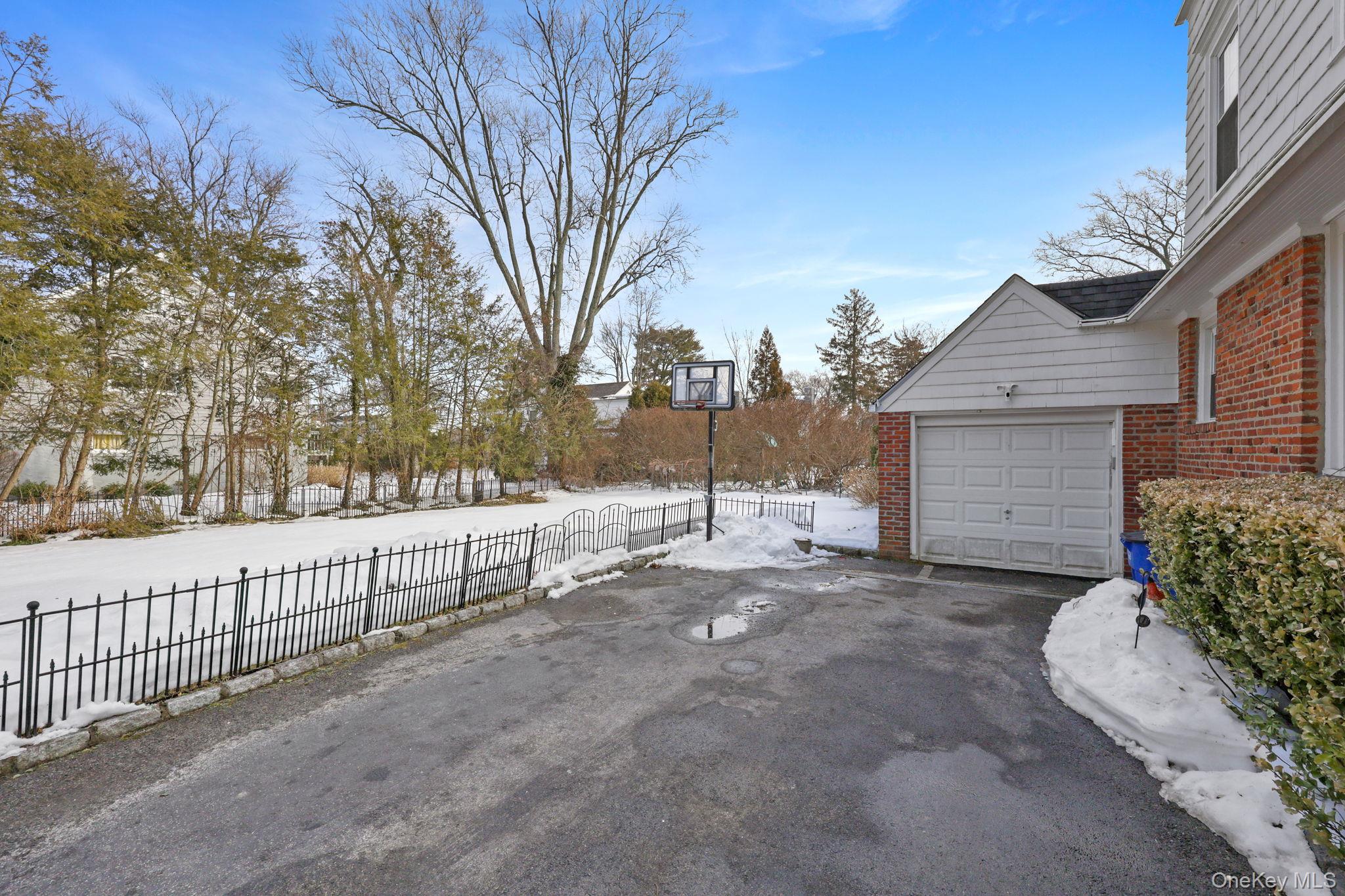 401 Heathcote Road Scarsdale, NY 10583 - Photo 37 of 41 a view of a house with a snow in the yard