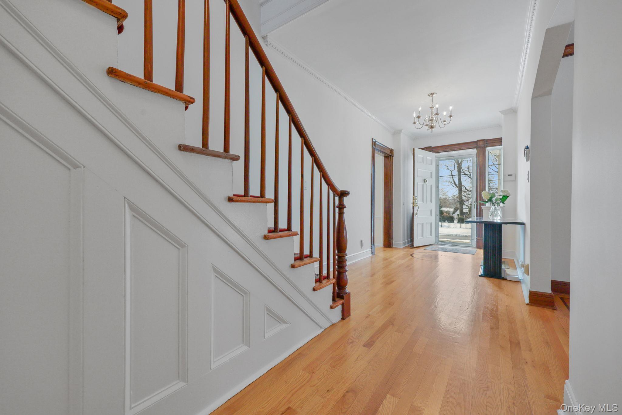 401 Heathcote Road Scarsdale, NY 10583 - Photo 4 of 41 a view of a hallway with wooden floor and staircase