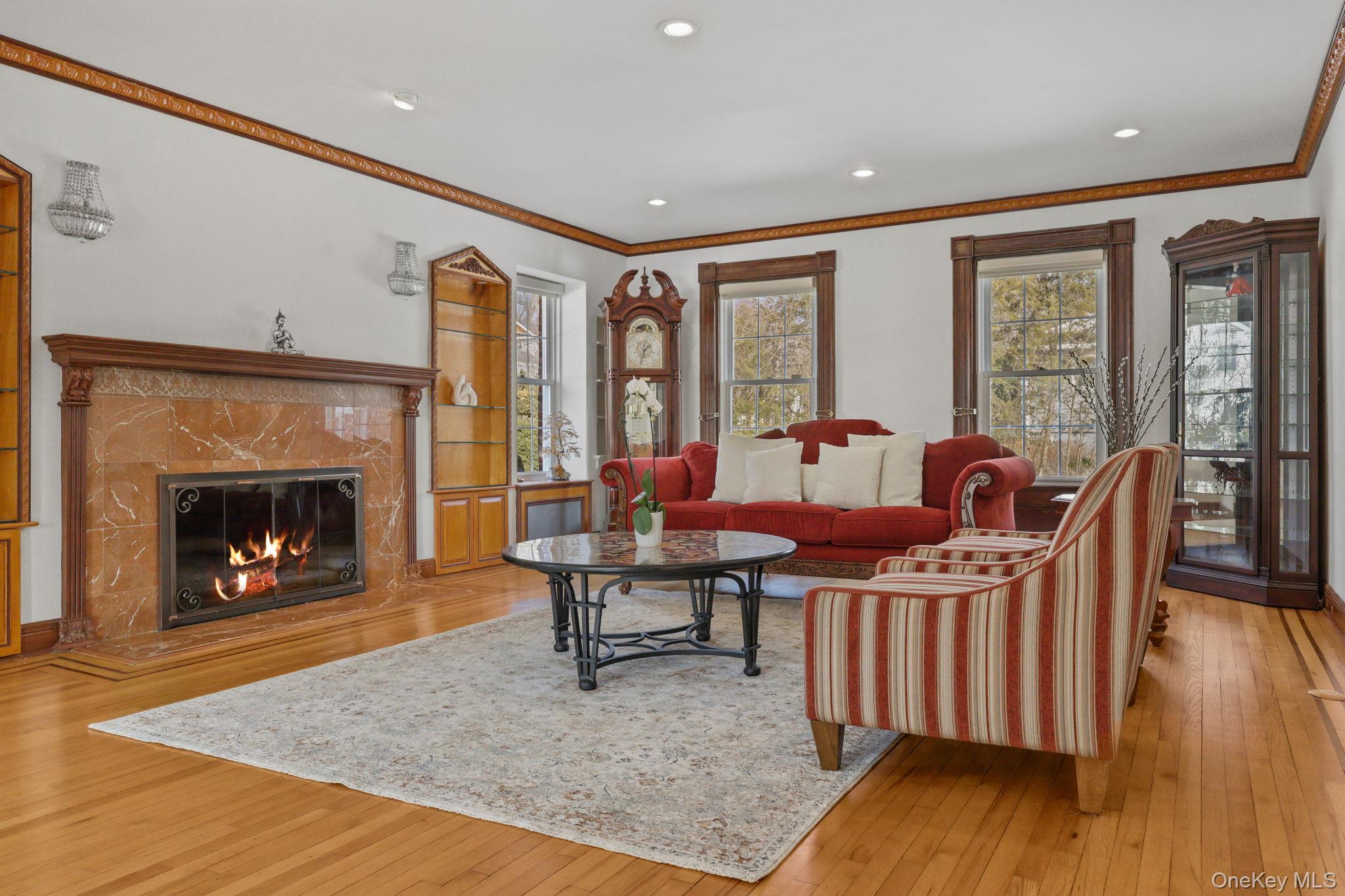 401 Heathcote Road Scarsdale, NY 10583 - Photo 6 of 41 a living room with furniture a table and a fireplace