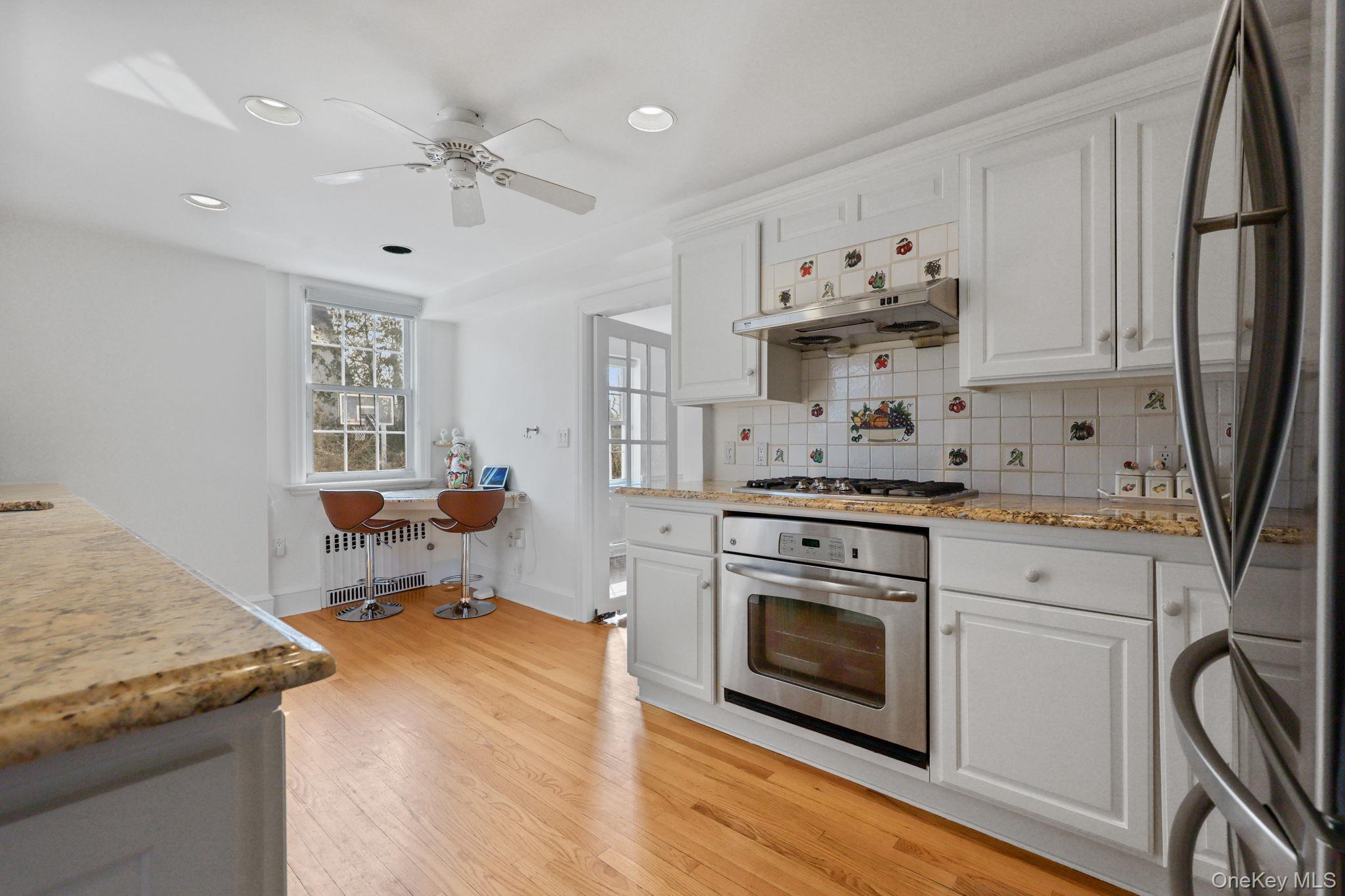401 Heathcote Road Scarsdale, NY 10583 - Photo 10 of 41 a kitchen with stainless steel appliances granite countertop a stove refrigerator and cabinets