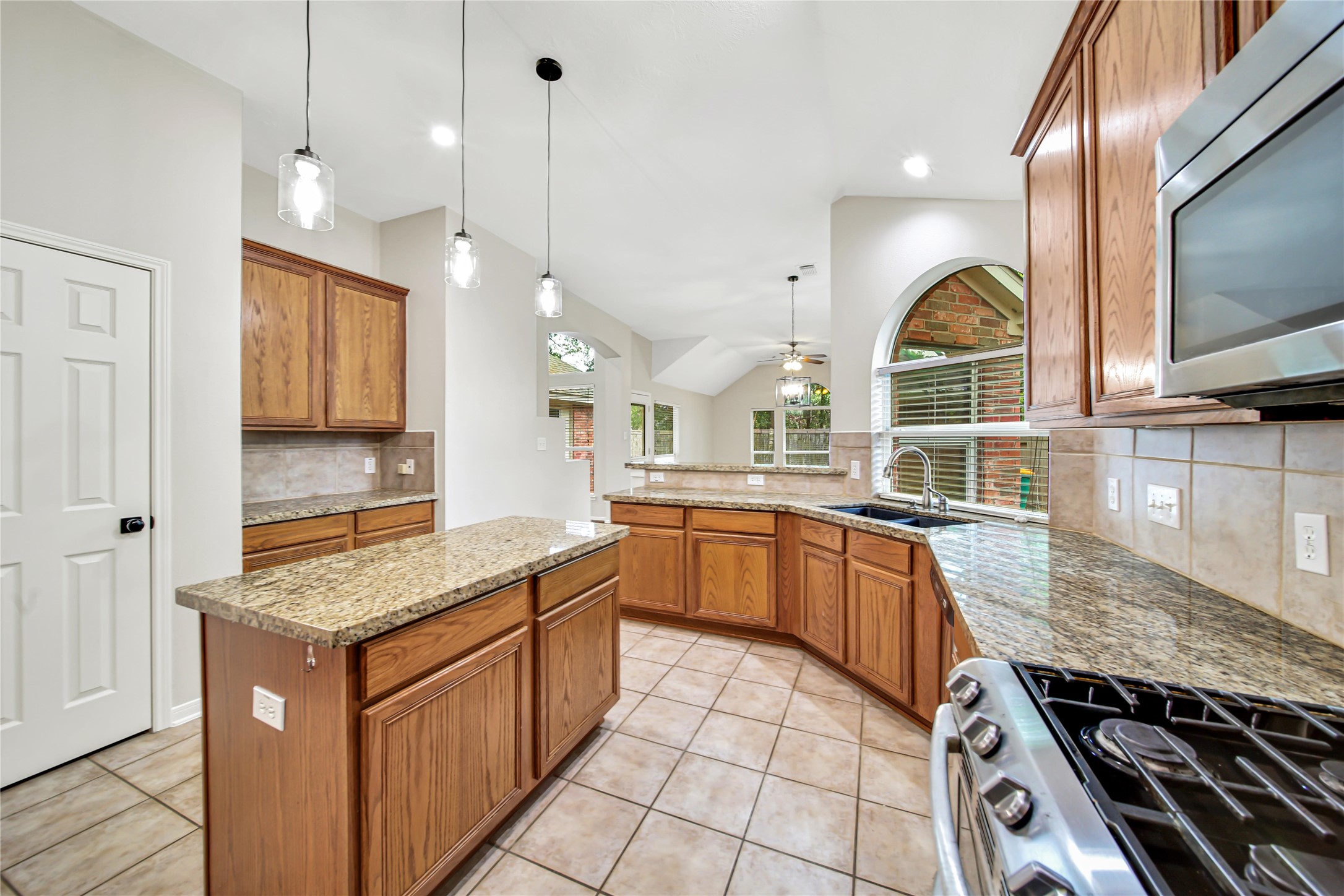 14526 Red Tailed Hawk Lane Houston, TX 77044 - Photo 12 of 40 a kitchen with stainless steel appliances granite countertop a stove and a sink
