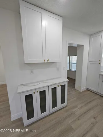 a view of a kitchen with wooden floor