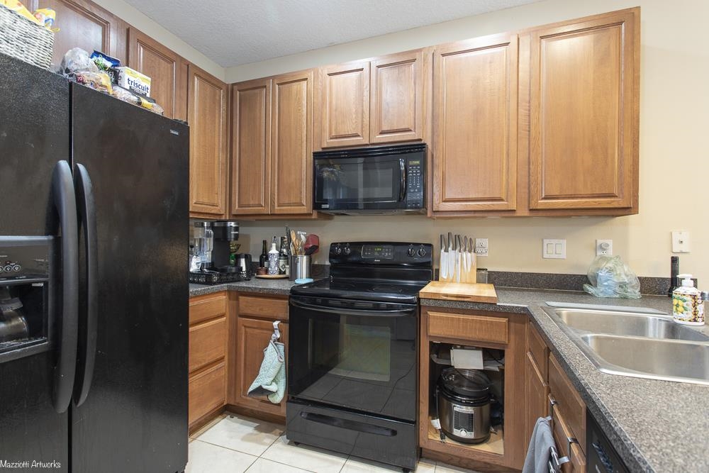 428 Cabernet Place St. Augustine, FL 32084 - Photo 5 of 21 a kitchen with granite countertop a refrigerator stove and microwave