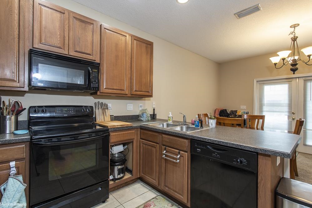 428 Cabernet Place St. Augustine, FL 32084 - Photo 6 of 21 a kitchen with granite countertop a stove microwave and sink