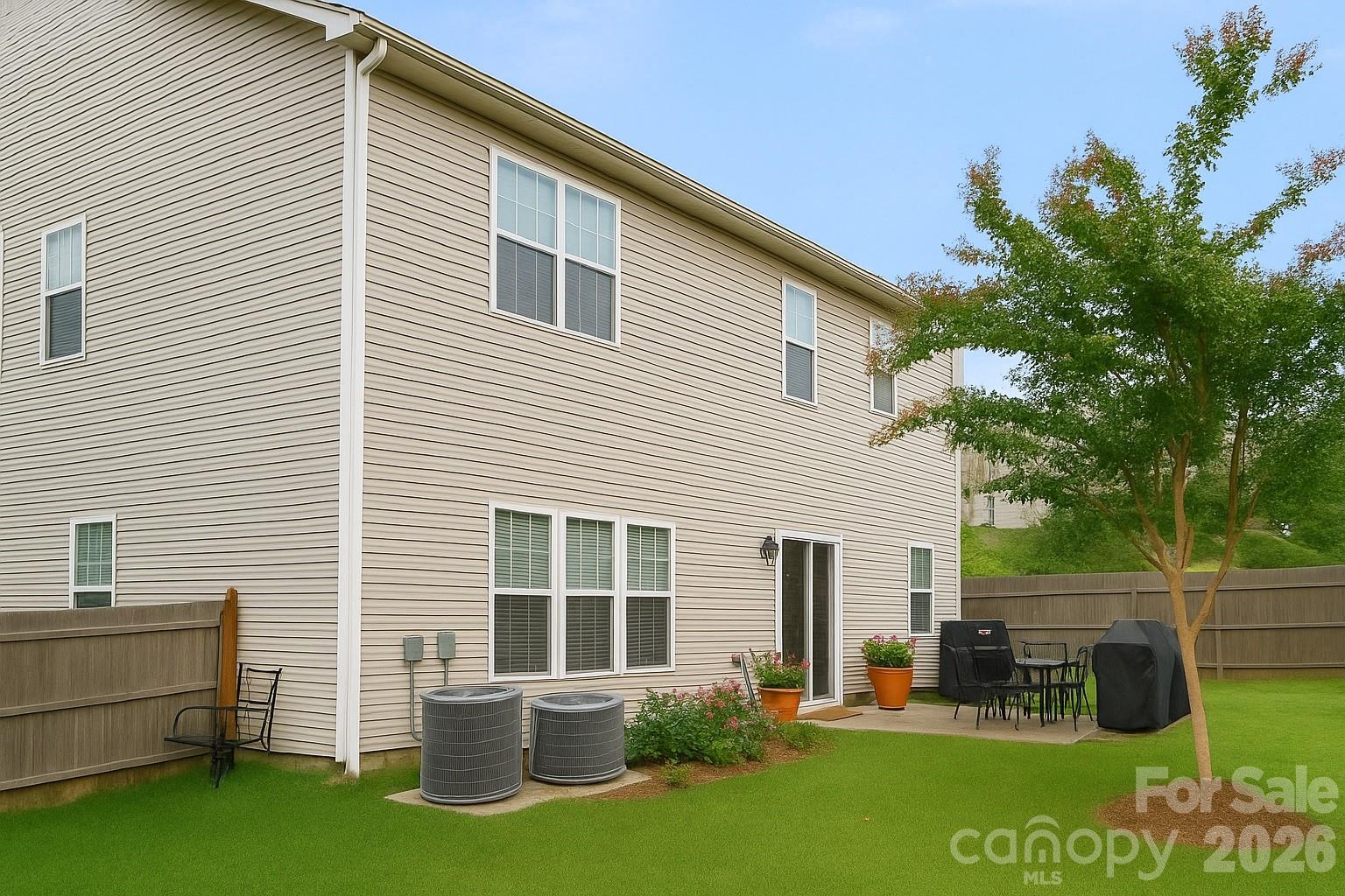 6639 Ruth Ferrell Court Charlotte, NC 28269 - Photo 2 of 30 a view of backyard with barbeque grill and a large tree