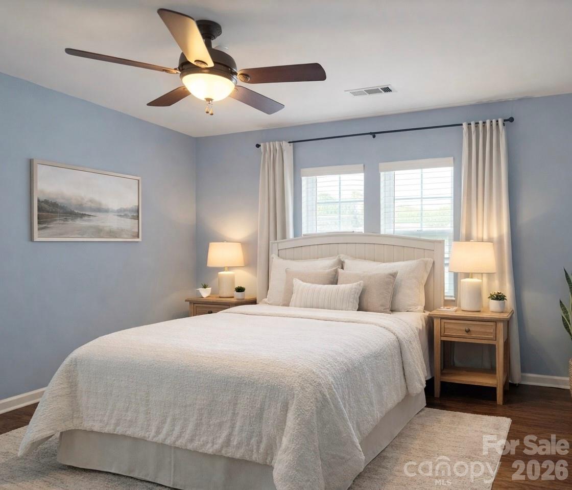6639 Ruth Ferrell Court Charlotte, NC 28269 - Photo 22 of 30 a bedroom with a large bed and a chandelier