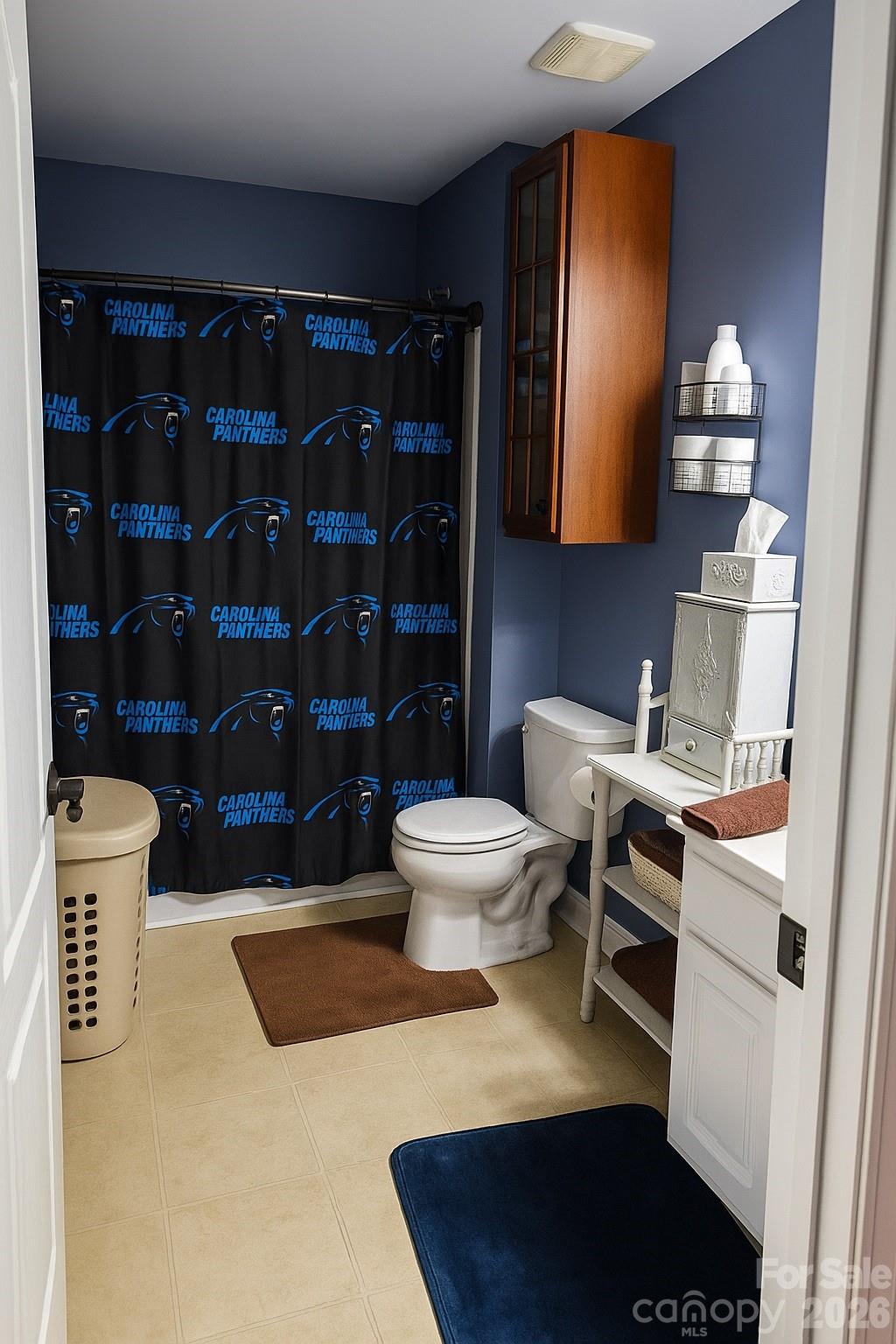 6639 Ruth Ferrell Court Charlotte, NC 28269 - Photo 25 of 30 a bathroom with a toilet a sink and a shower