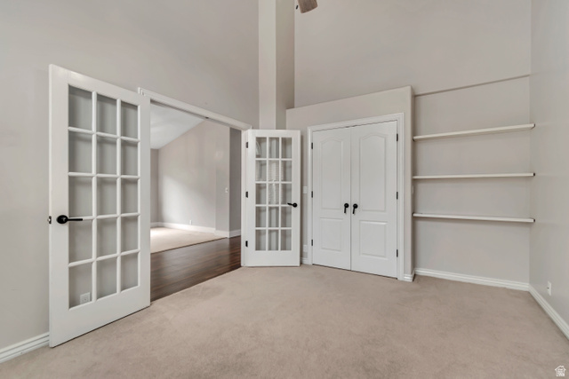 2154 Wasatch Boulevard Sandy, UT 84092 - Photo 7 of 55 Unfurnished bedroom featuring french doors, light carpet, and a high ceiling