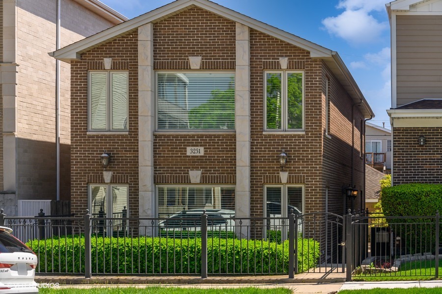 a view of a brick building next to a yard