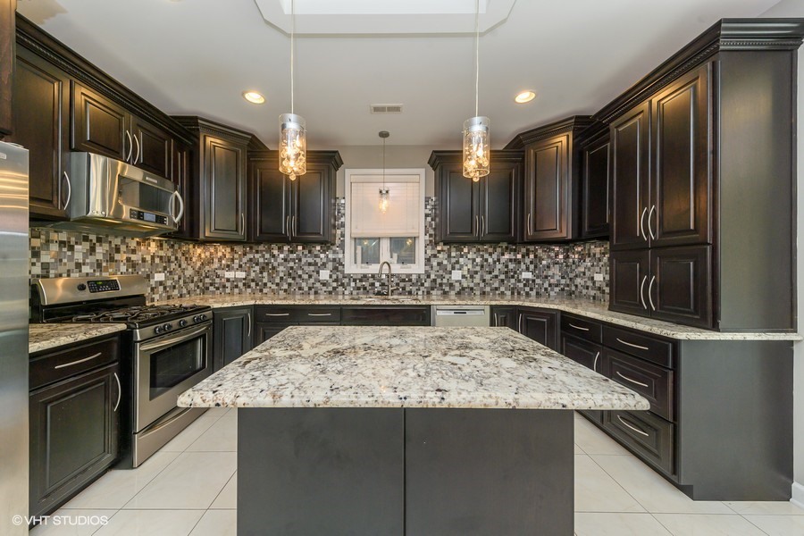 3251 South Normal Avenue Chicago, IL 60616 - Photo 3 of 12 a kitchen with a stove and a refrigerator