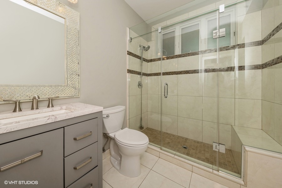 3251 South Normal Avenue Chicago, IL 60616 - Photo 6 of 12 a bathroom with a granite countertop sink a toilet and shower