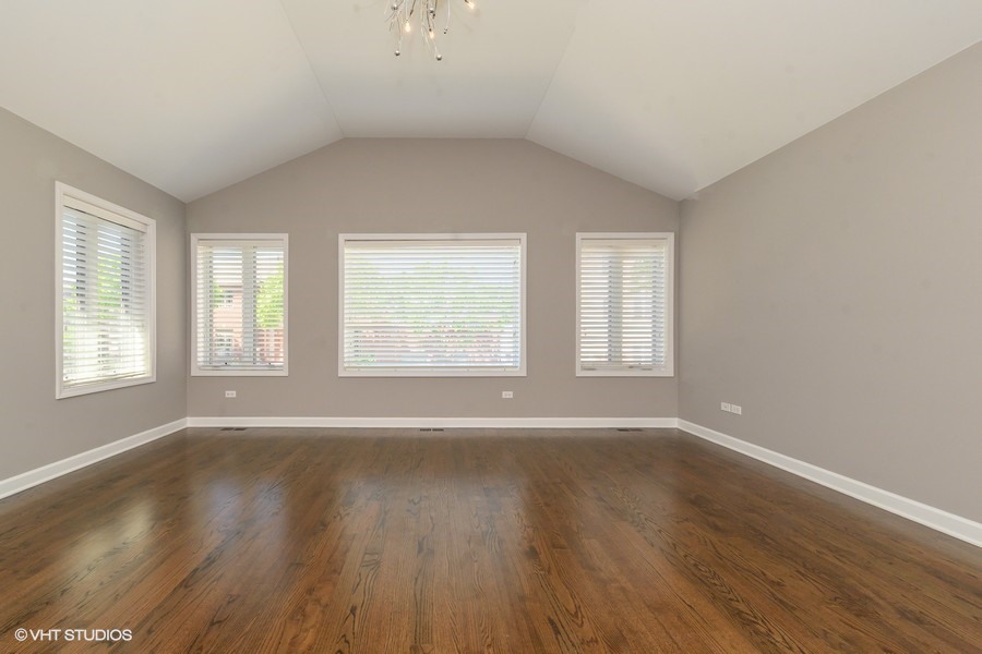 3251 South Normal Avenue Chicago, IL 60616 - Photo 8 of 12 an empty room with wooden floor and windows