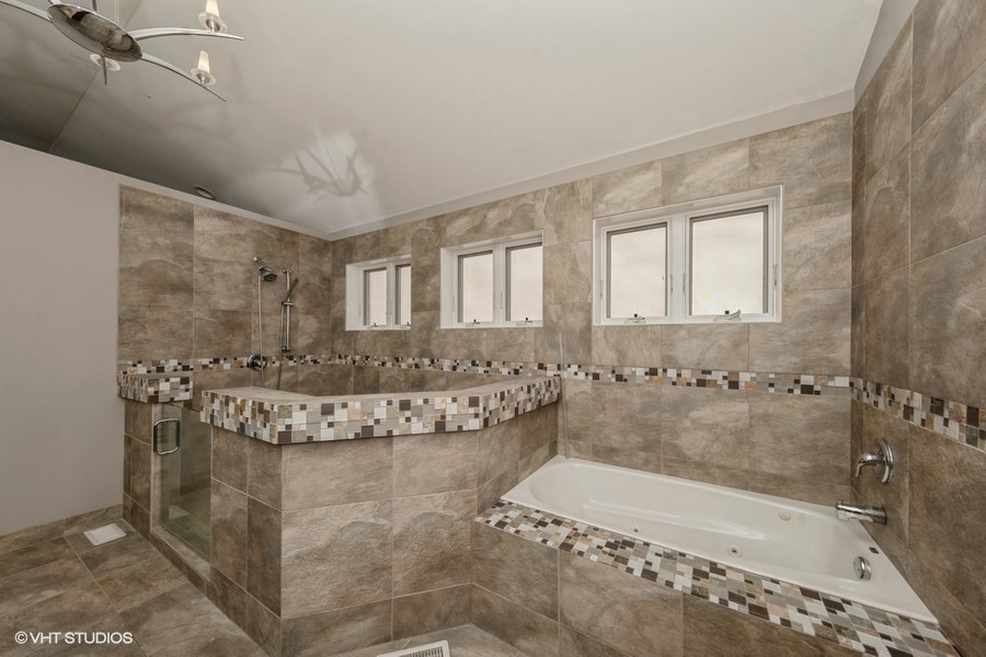 3251 South Normal Avenue Chicago, IL 60616 - Photo 9 of 12 a bathroom with a granite countertop bathtub sink and mirror