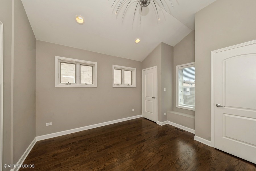 3251 South Normal Avenue Chicago, IL 60616 - Photo 10 of 12 an empty room with wooden floor and windows