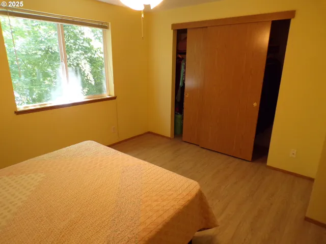 a bed sitting in a bedroom next to a window