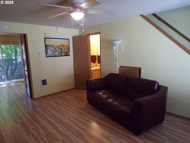 a living room with couch and wooden floor