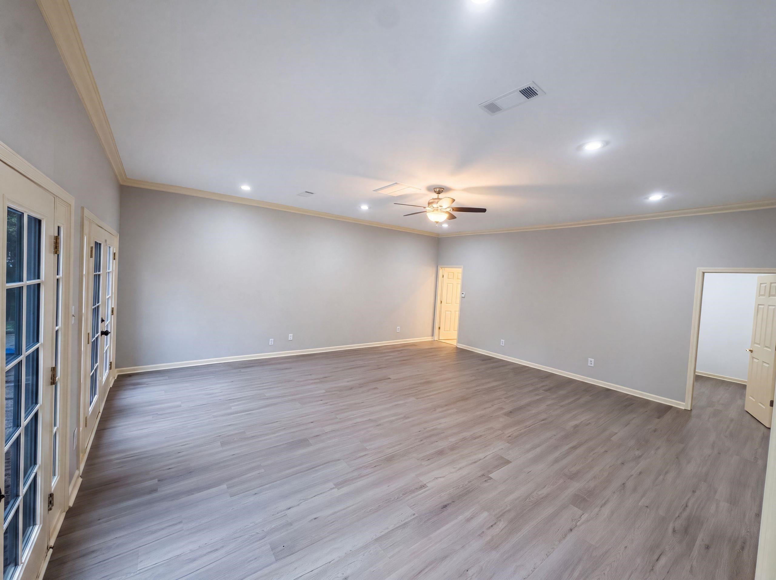 9424 Gotten Road Germantown, TN 38139 - Photo 10 of 27 Spacious room featuring wood-finish flooring, light gray walls, and crown molding