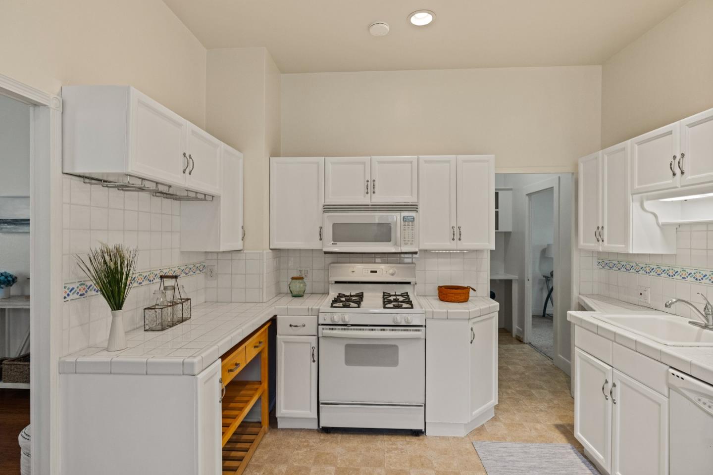 21 Fourth Street Spreckels, CA 93962 - Photo 11 of 31 a kitchen with stainless steel appliances white cabinets and white appliances