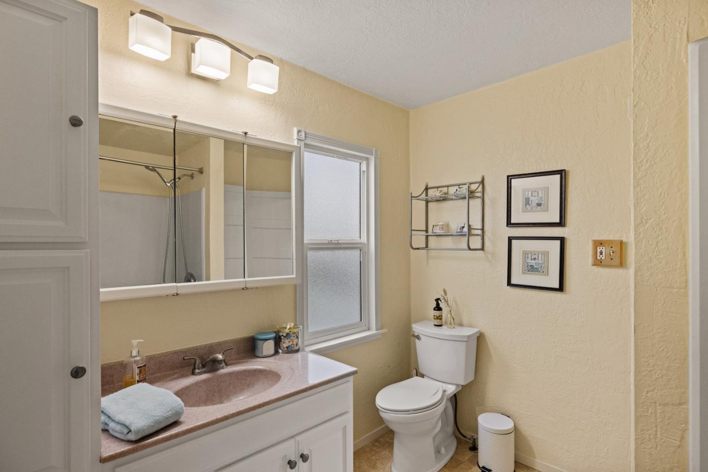 21 Fourth Street Spreckels, CA 93962 - Photo 16 of 31 a bathroom with a granite countertop toilet sink and mirror