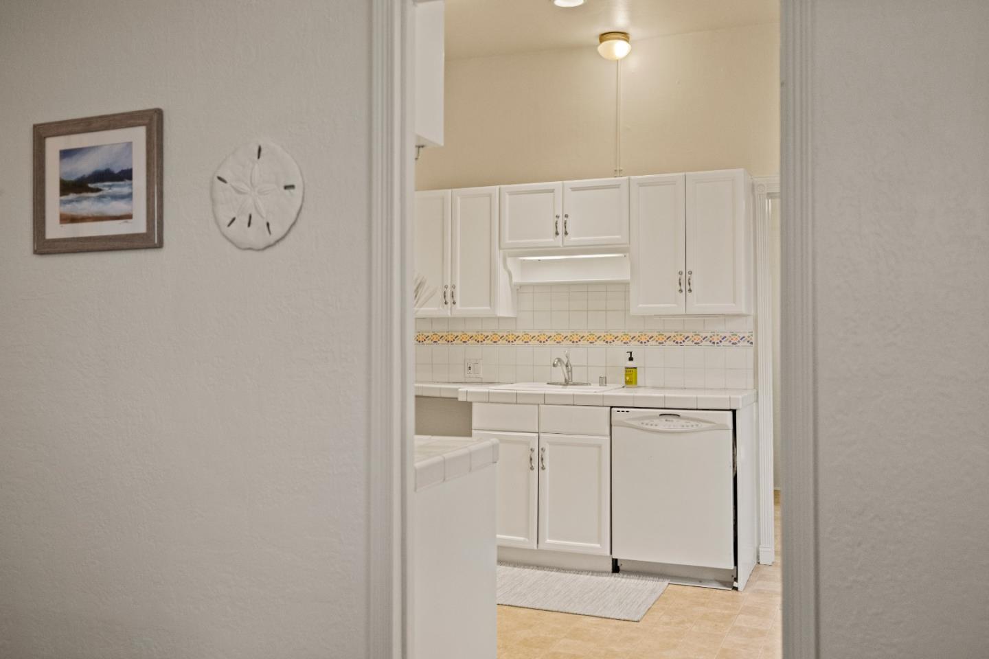 21 Fourth Street Spreckels, CA 93962 - Photo 8 of 31 a kitchen with white cabinets and white appliances