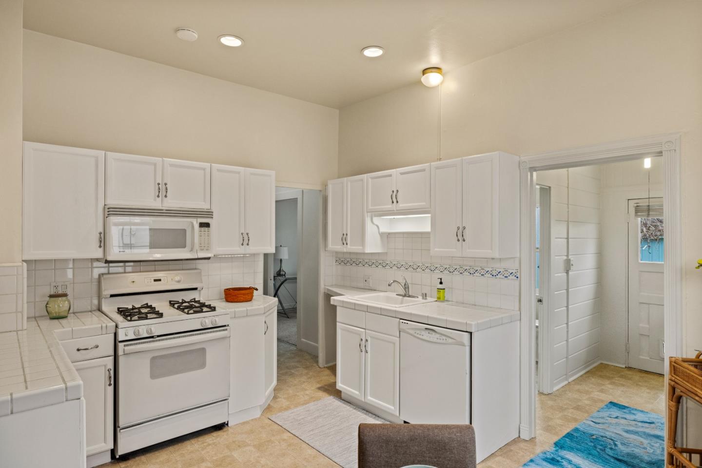 21 Fourth Street Spreckels, CA 93962 - Photo 9 of 31 a kitchen with white cabinets sink and white appliances