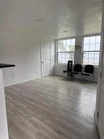 a view of a livingroom with furniture window and wooden floor