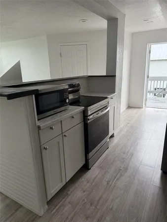 a kitchen with granite countertop a stove and a sink