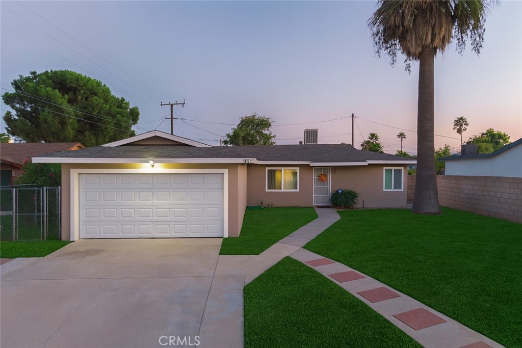 a front view of a house with yard and garage