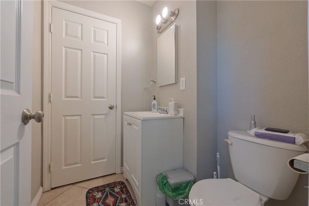 1083 Lorraine Place Rialto, CA 92376 - Photo 13 of 20 a bathroom with a sink a toilet and vanity