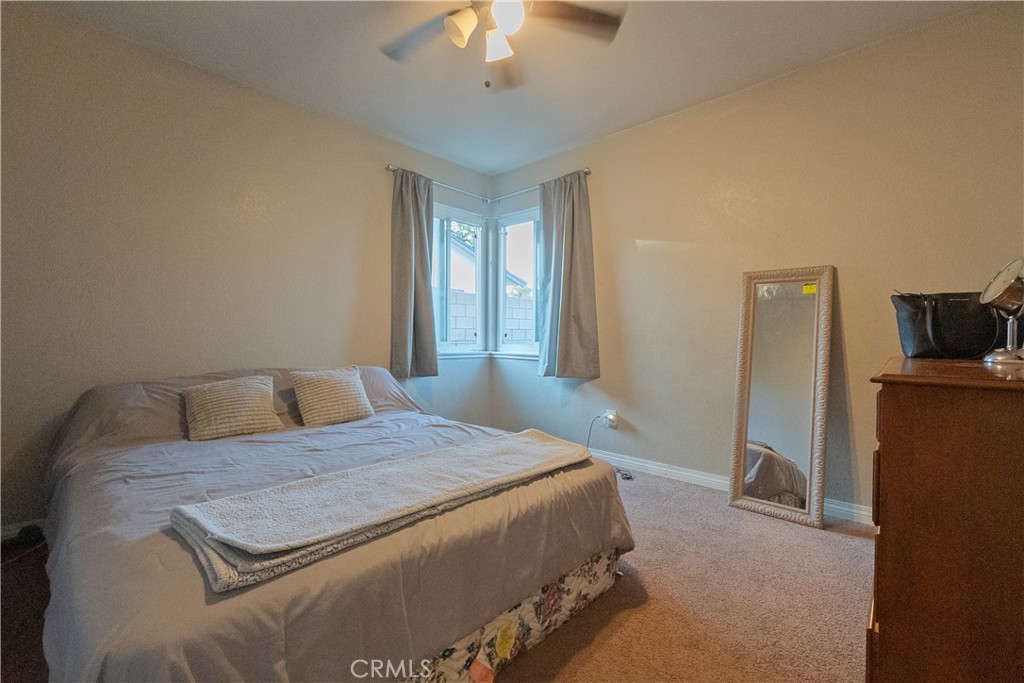 1083 Lorraine Place Rialto, CA 92376 - Photo 15 of 20 a bedroom with a bed and a chandelier