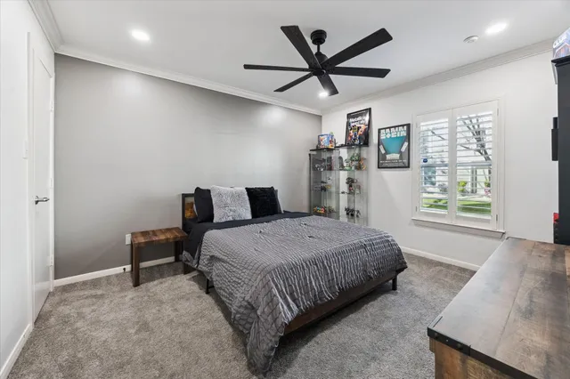 a bedroom with a bed a window and a chandelier