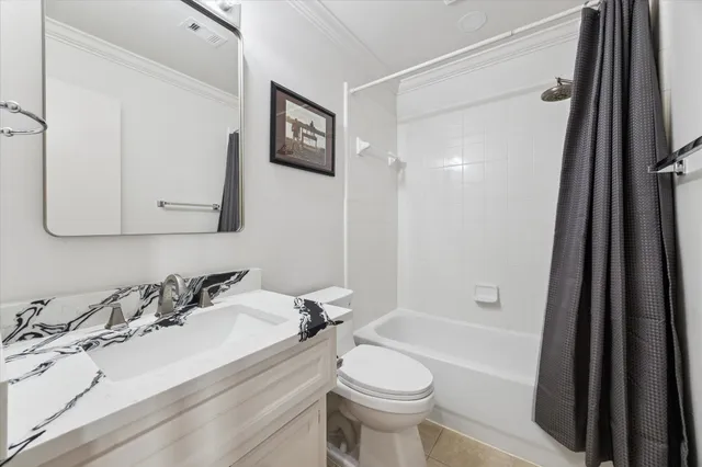 a bathroom with a granite countertop sink mirror vanity and toilet
