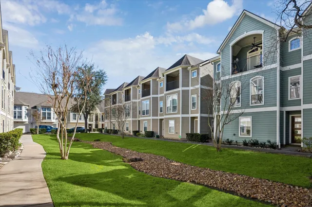 a front view of a building with a yard