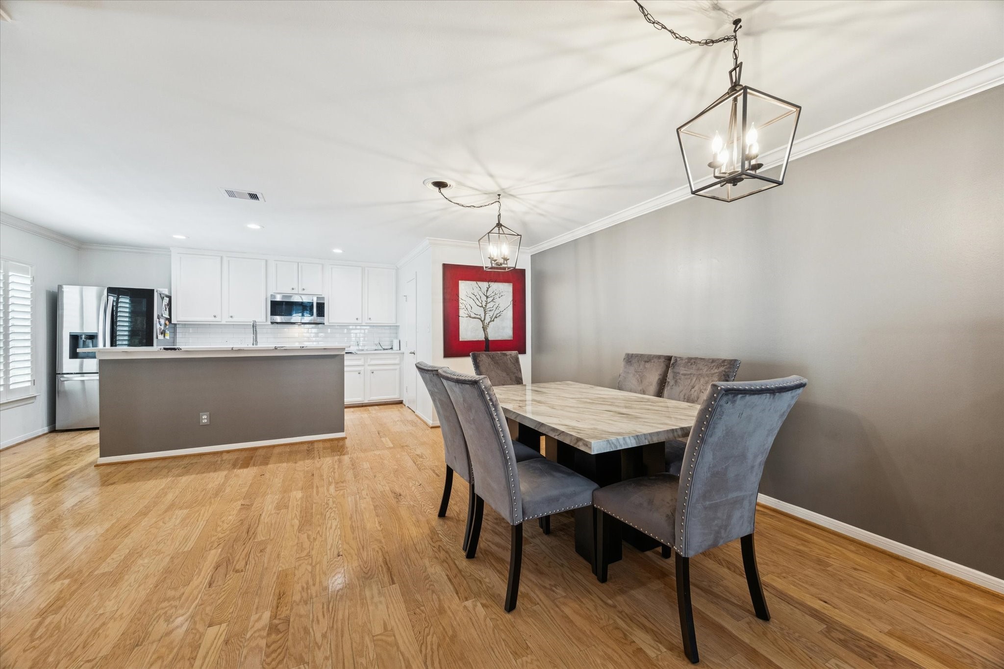 1259 West 17th Street Houston, TX 77008 - Photo 5 of 22 a view of a dining room with furniture wooden floor and a chandelier