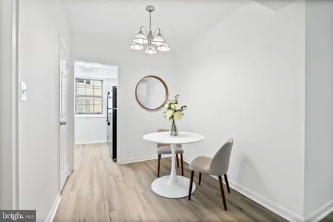 a view of a dining room with furniture wooden floor and chandelier