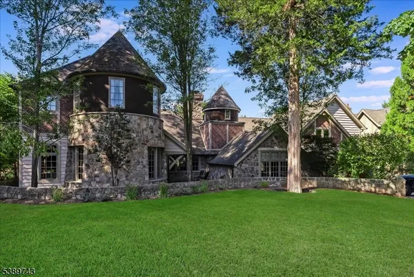 a front view of house with a garden