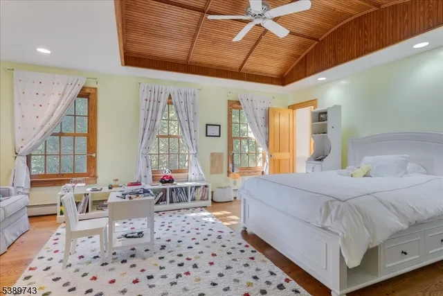 a bedroom with a bed and glass windows