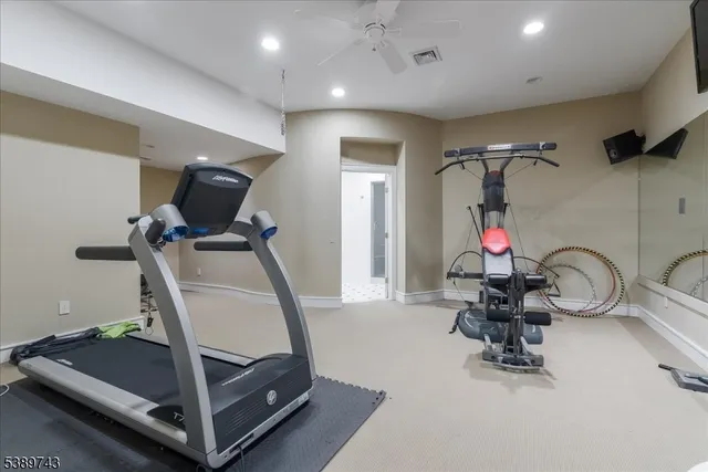 a room with gym equipment and a mirror