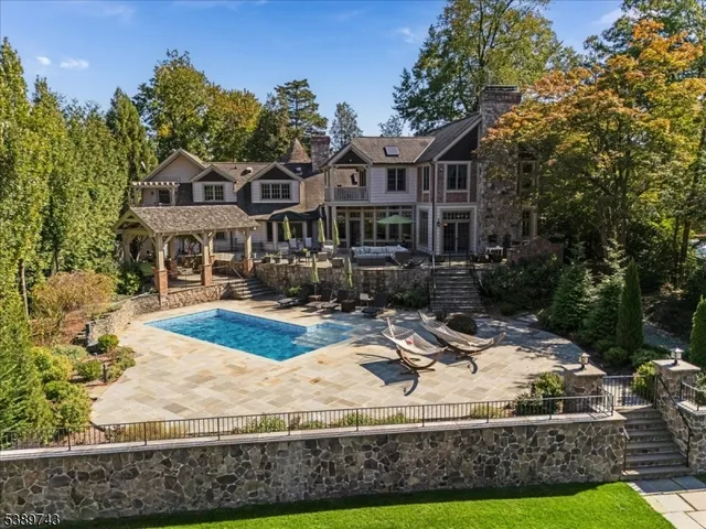 a view of house with yard and trees in the background
