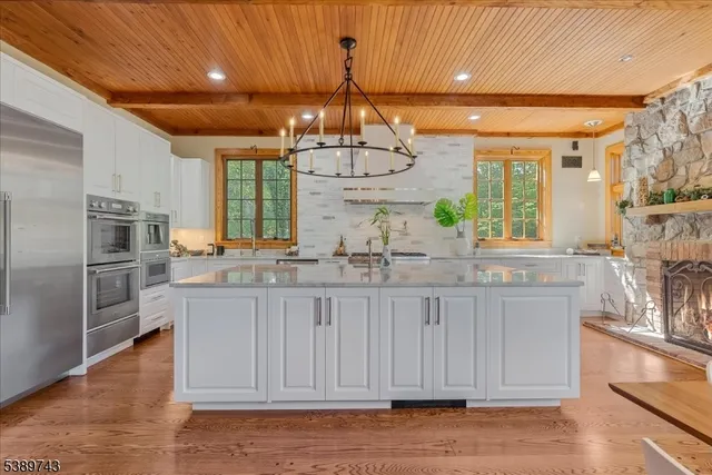 a kitchen with granite countertop white cabinets and refrigerator